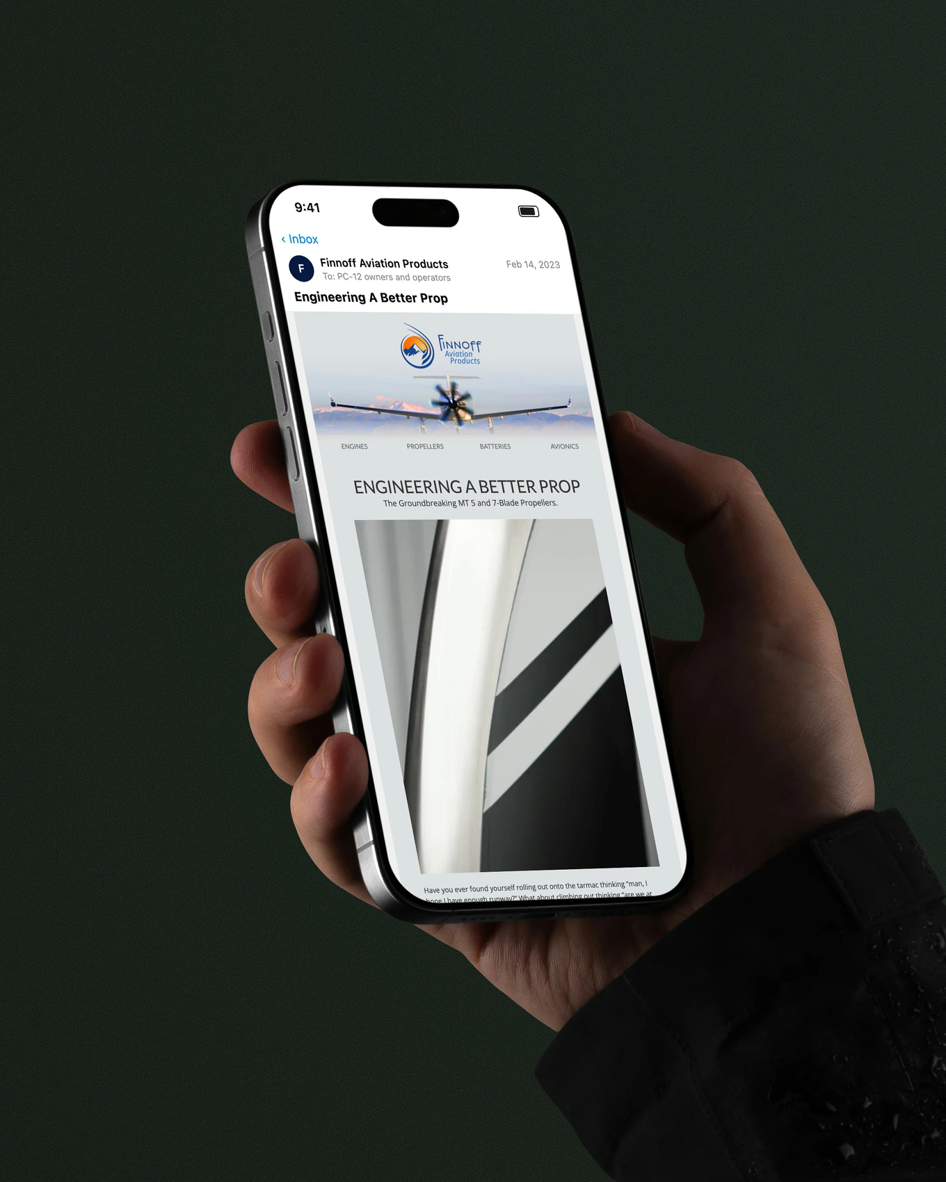 A hand holding an iPhone open on the Engineering A Better Prop email from Finnoff Aviation Products