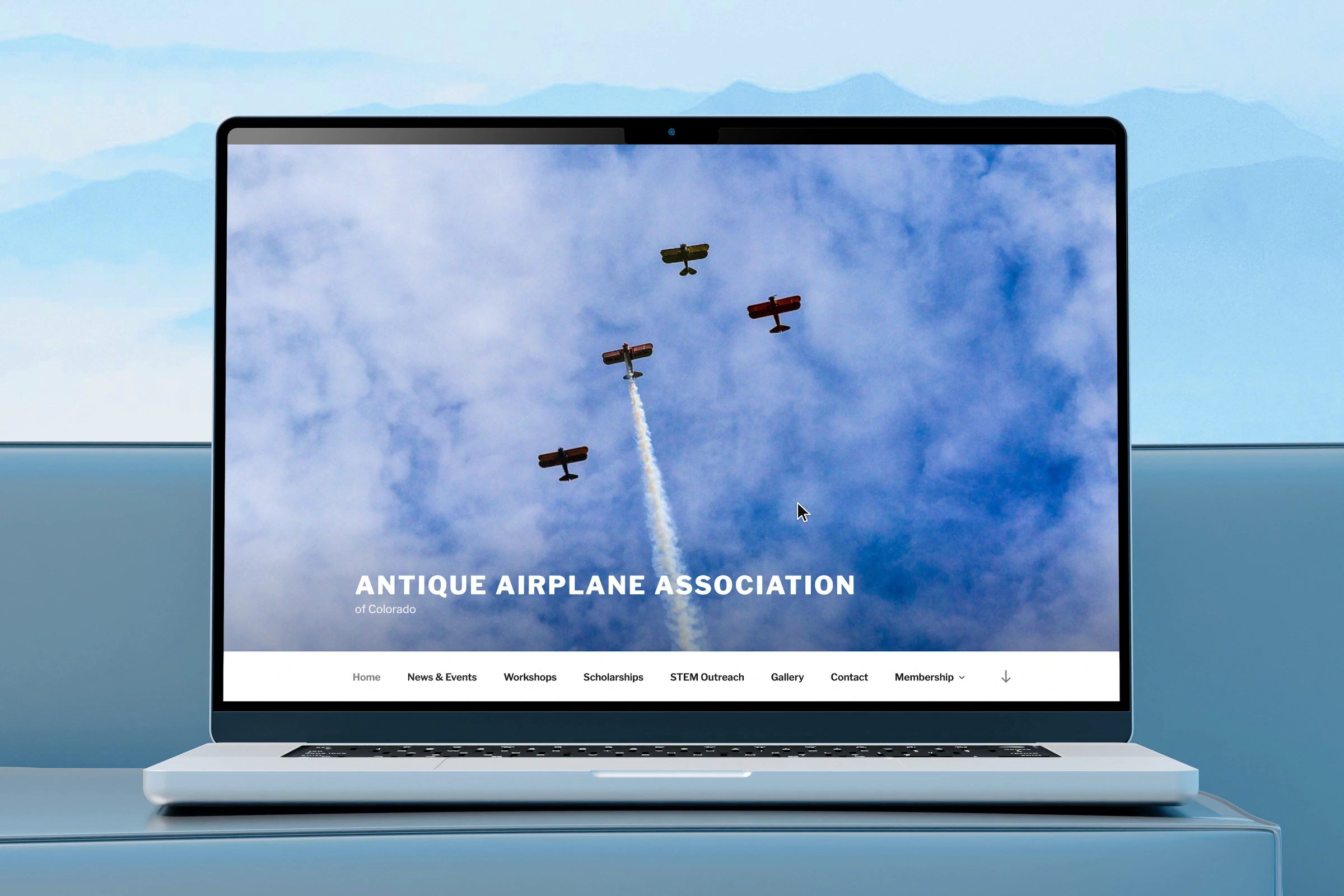 The AAA Colorado website on a laptop, open at the homepage menu