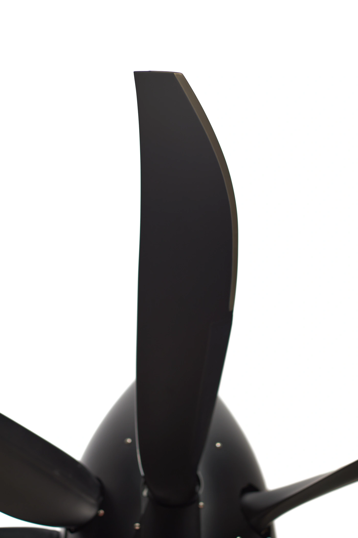One black blade of an MT seven-blade propeller rising from the spinner, against white