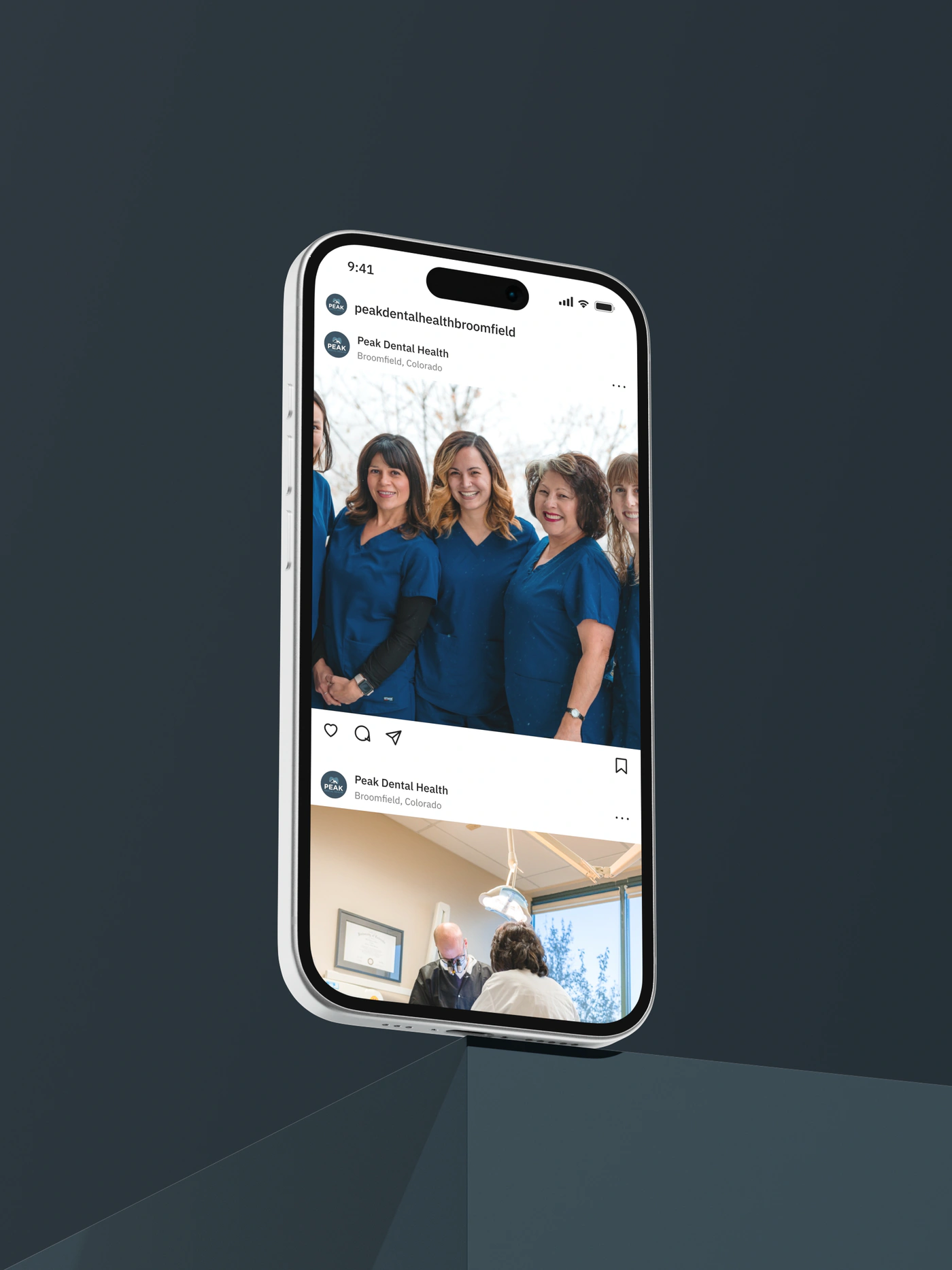 A phone standing on the point of a block, showing the Peak Dental Health feed: the team in their navy scrubs